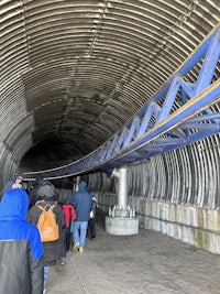 a group of people standing in a tunnel